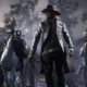 A group of outlaws wearing dark clothes and hanging out in a swamp at night as seen in RDO.
